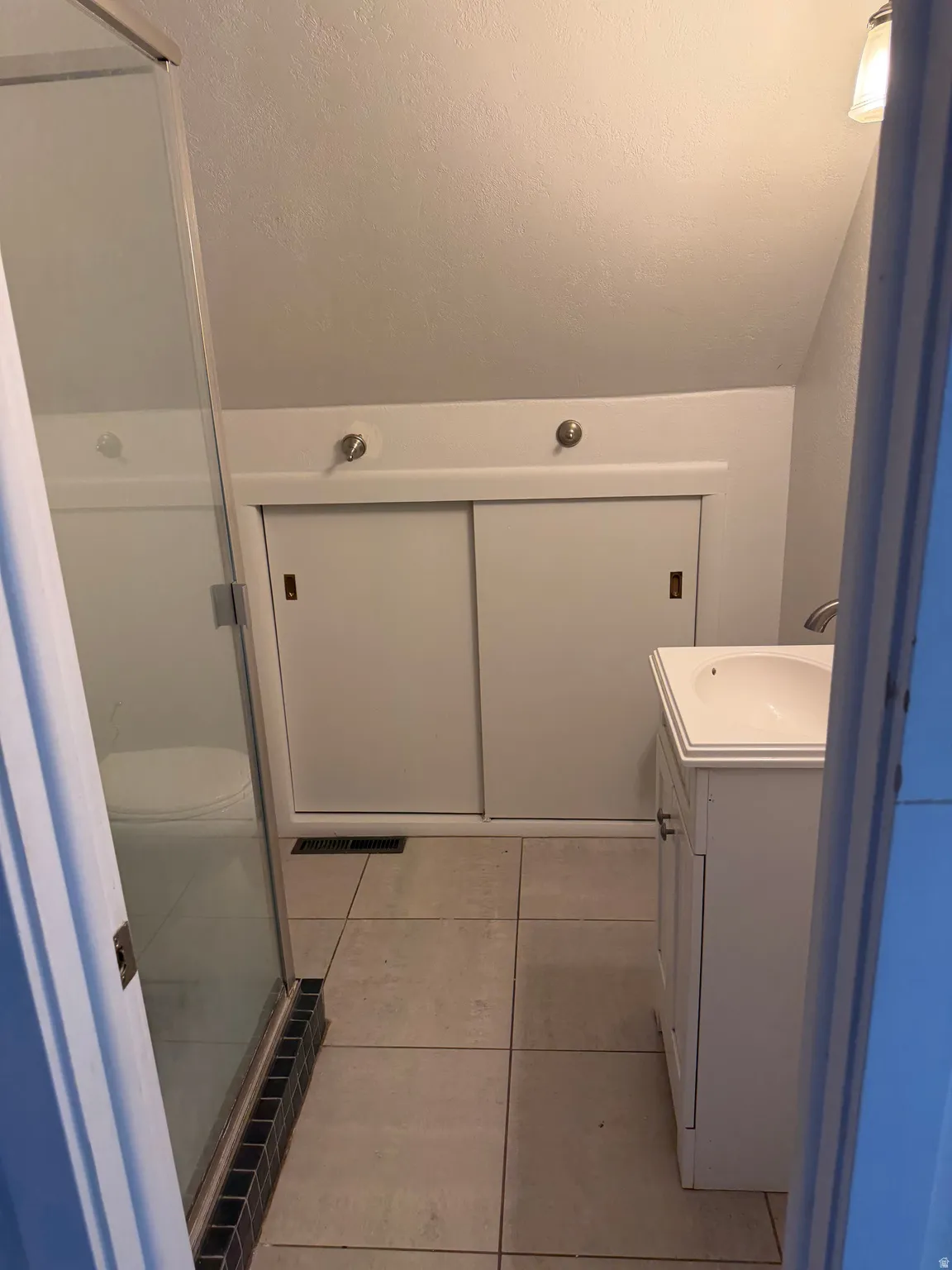 Bathroom on second level with vanity and stall shower.