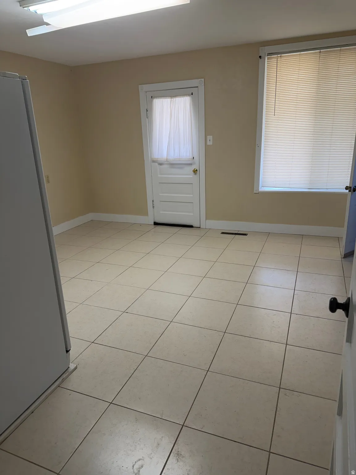 Spare room with light tile patterned floors