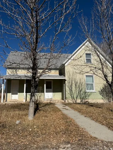 View of front of house with stucco siding and a porch