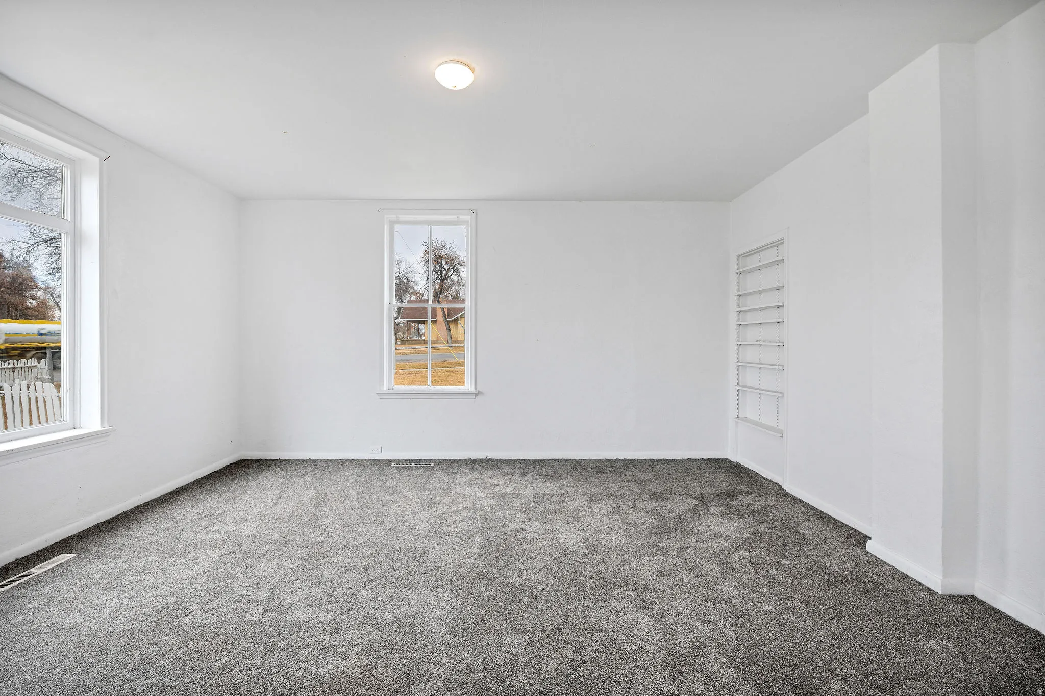 Carpeted empty room with baseboards