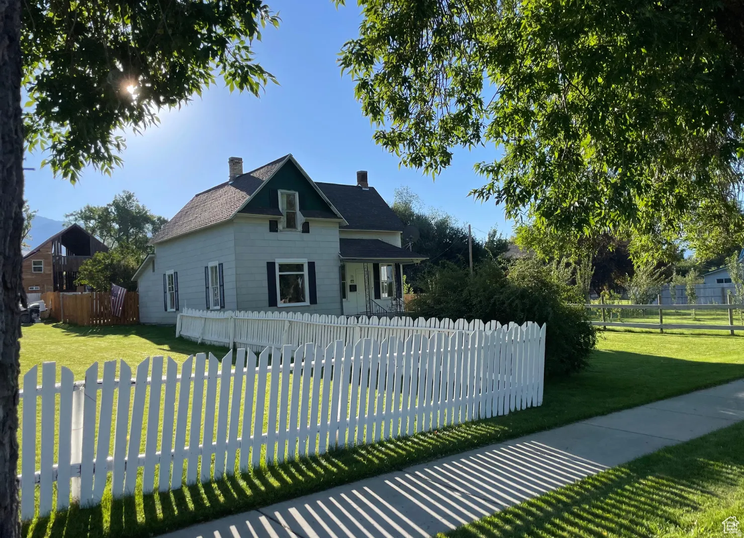 View of front of house with a fenced front yard and a chimney