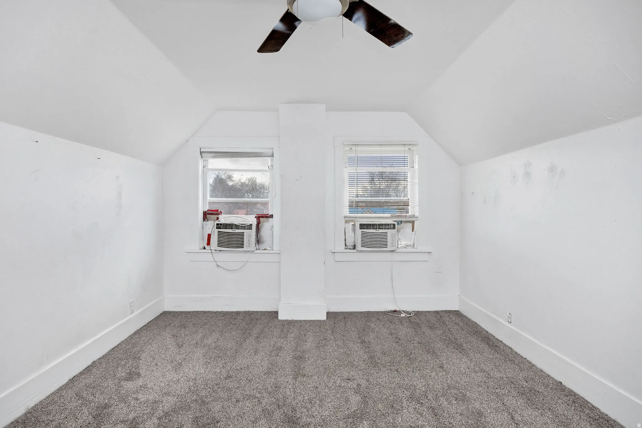 Bonus room featuring carpet flooring and a ceiling fan