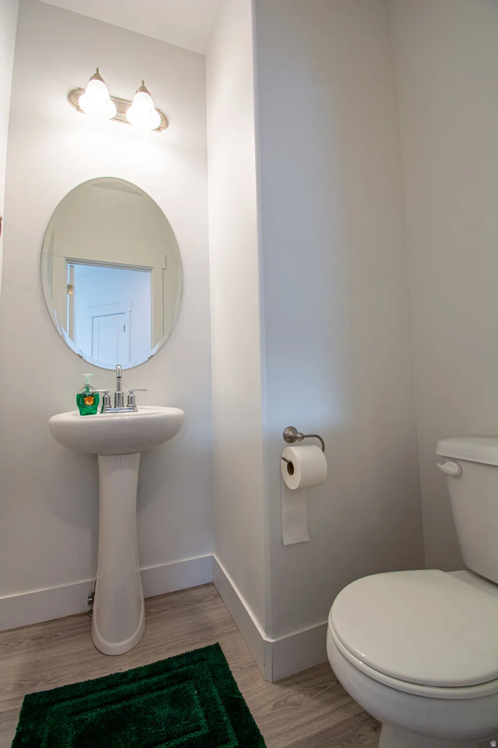 Bathroom featuring toilet and light wood-type flooring