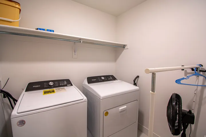 Washroom featuring separate washer and dryer and baseboards
