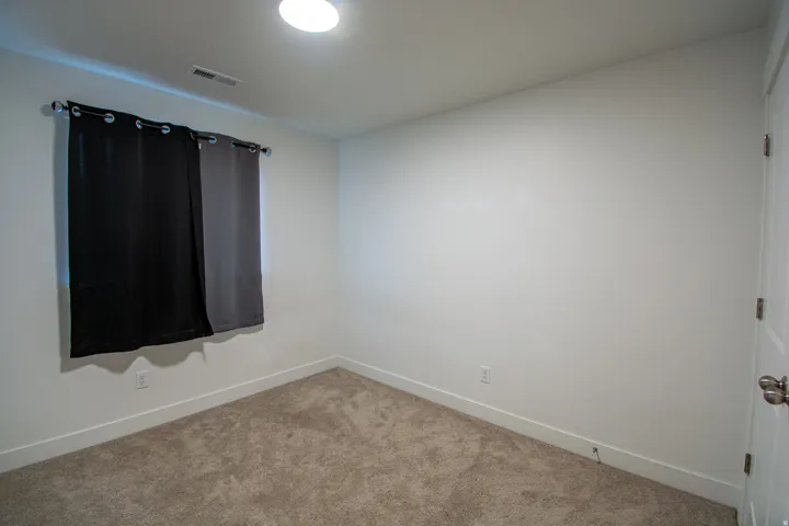 Empty room with baseboards and carpet floors