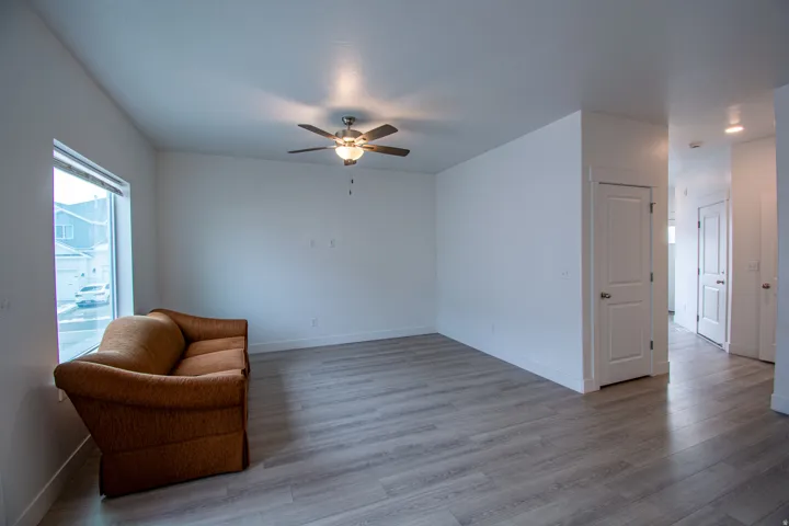 Unfurnished room featuring wood finished floors and ceiling fan