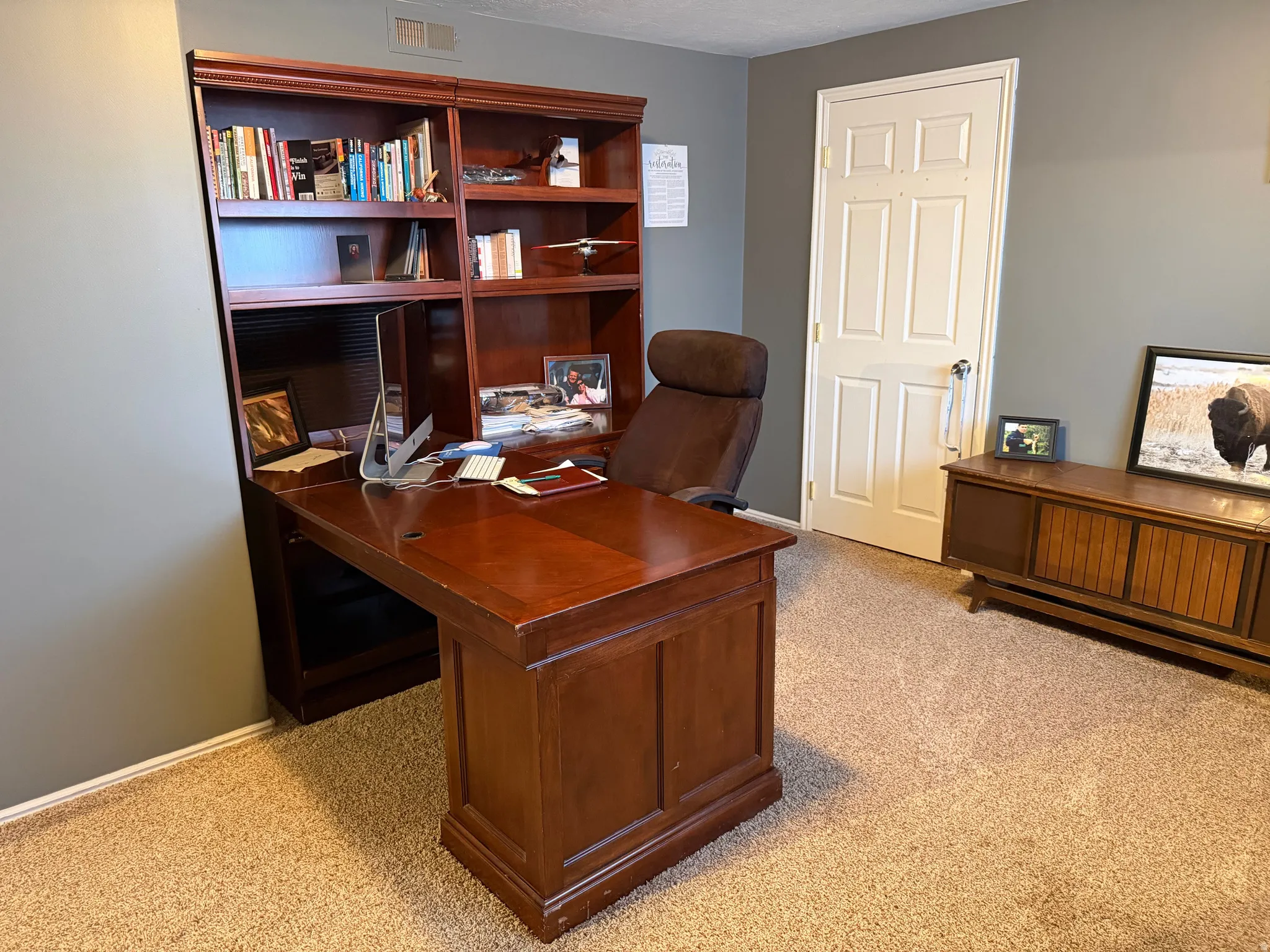 Office space featuring light colored carpet and baseboards