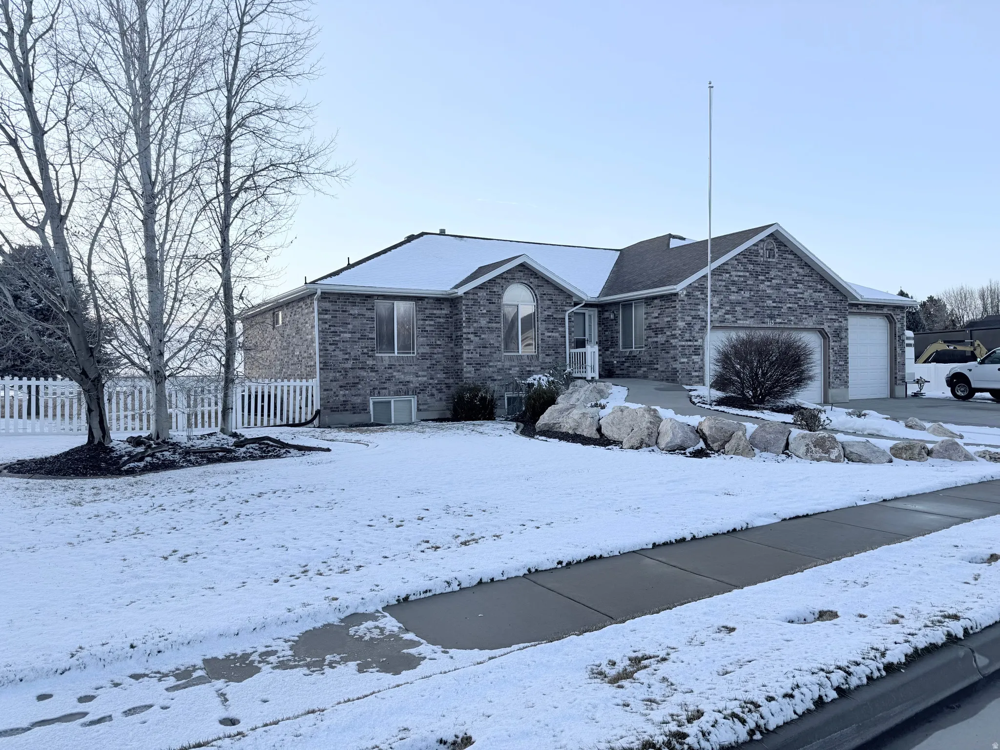 Ranch-style house featuring a garage and brick siding