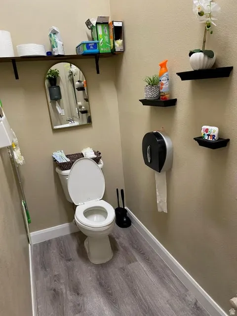 Bathroom featuring toilet and wood finished floors