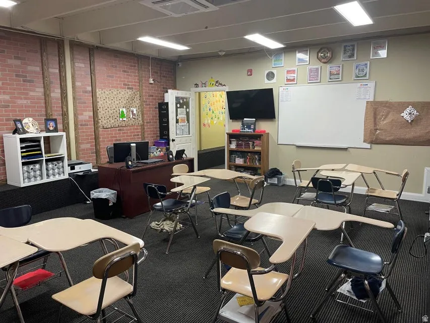 Home office featuring brick wall