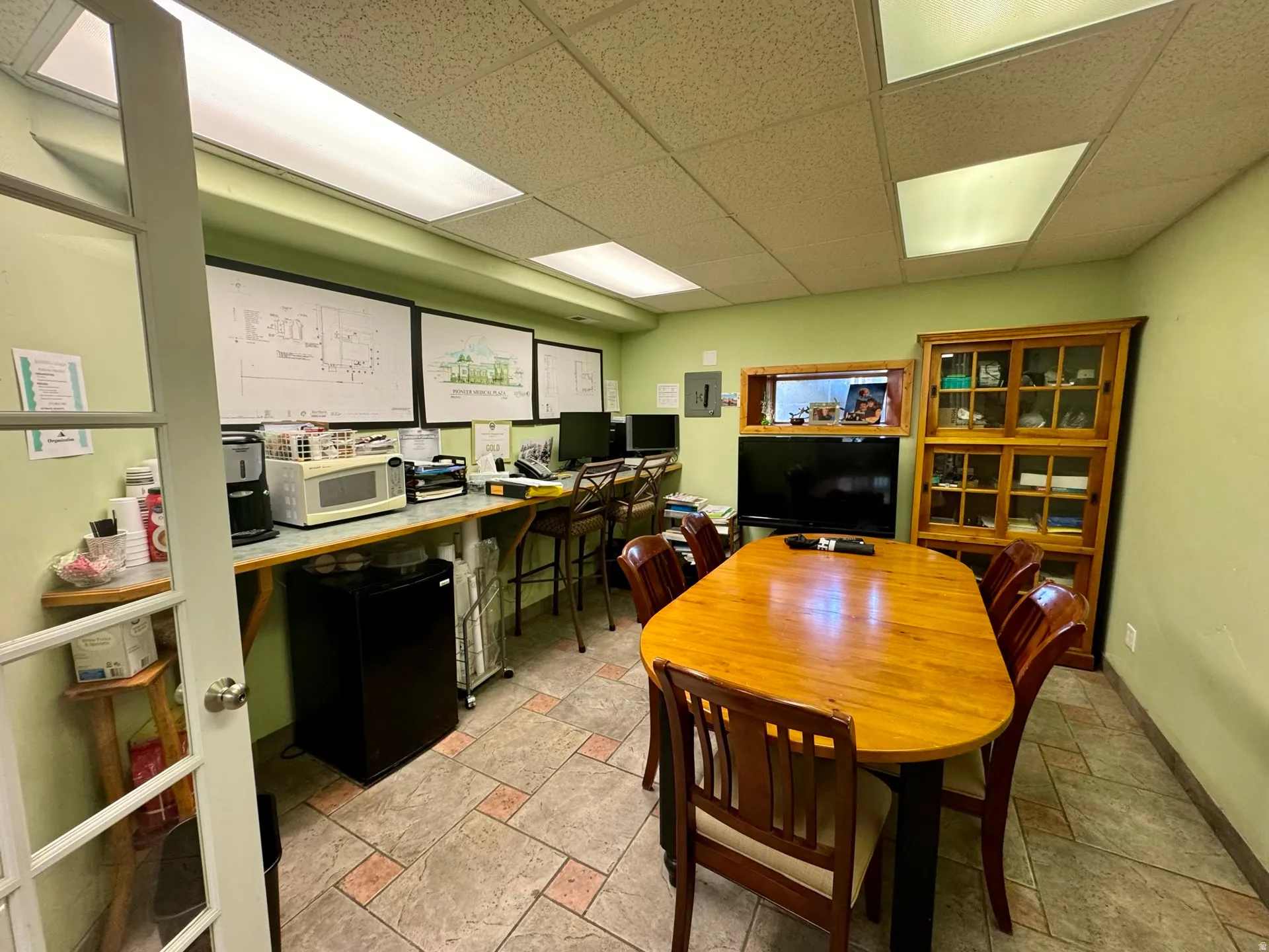 Office area featuring a paneled ceiling and built in desk
