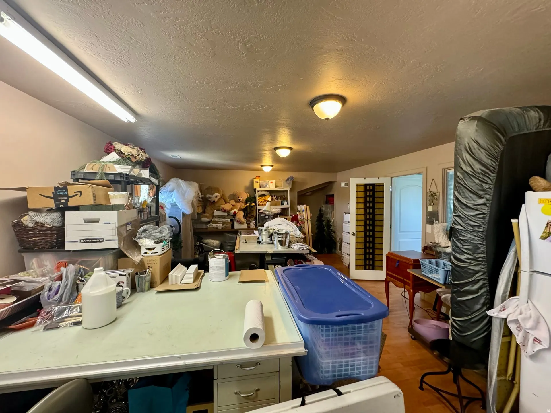 Misc room featuring a textured ceiling and dark wood-style floors
