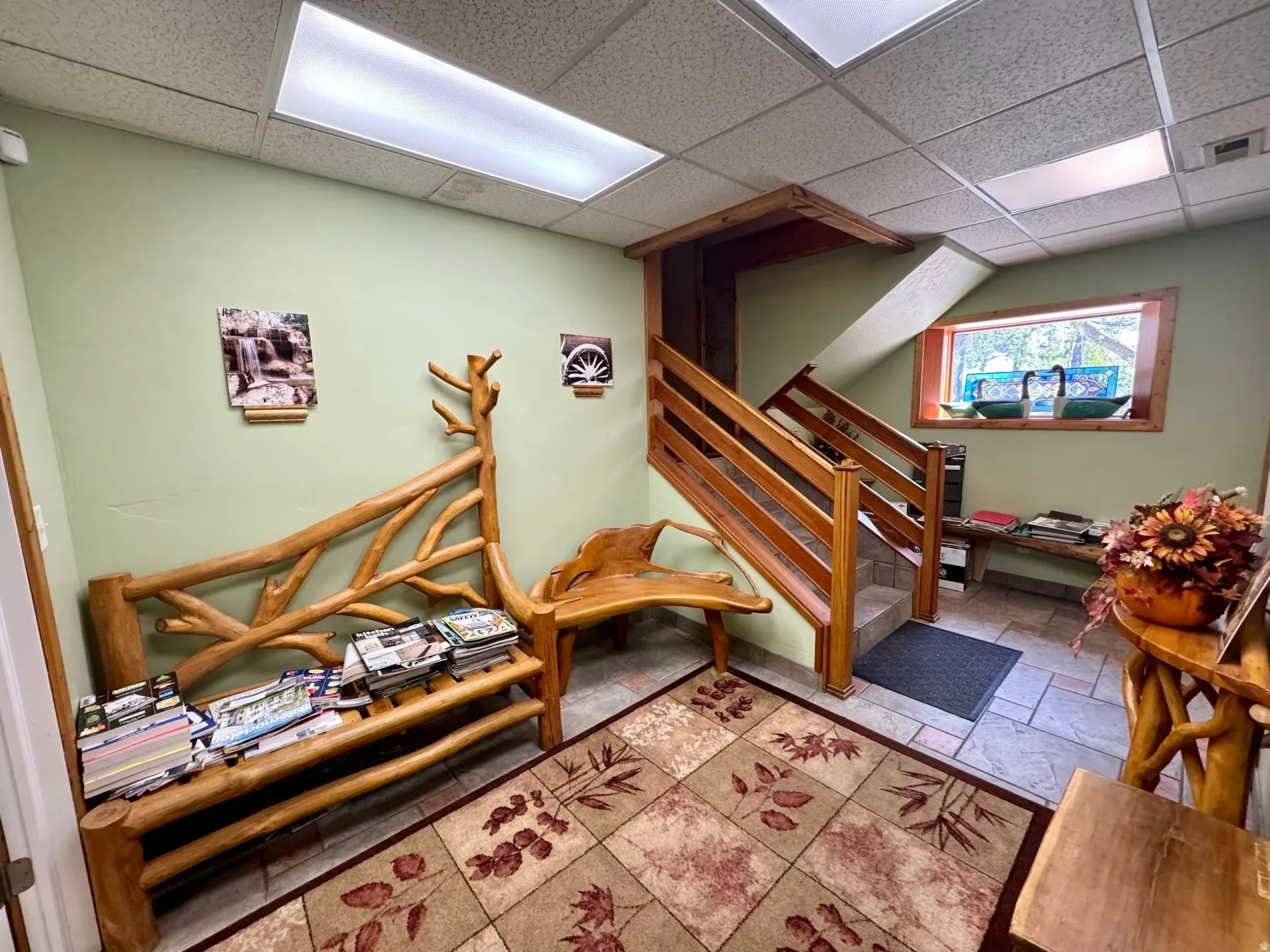 Playroom with a drop ceiling and stone tile flooring