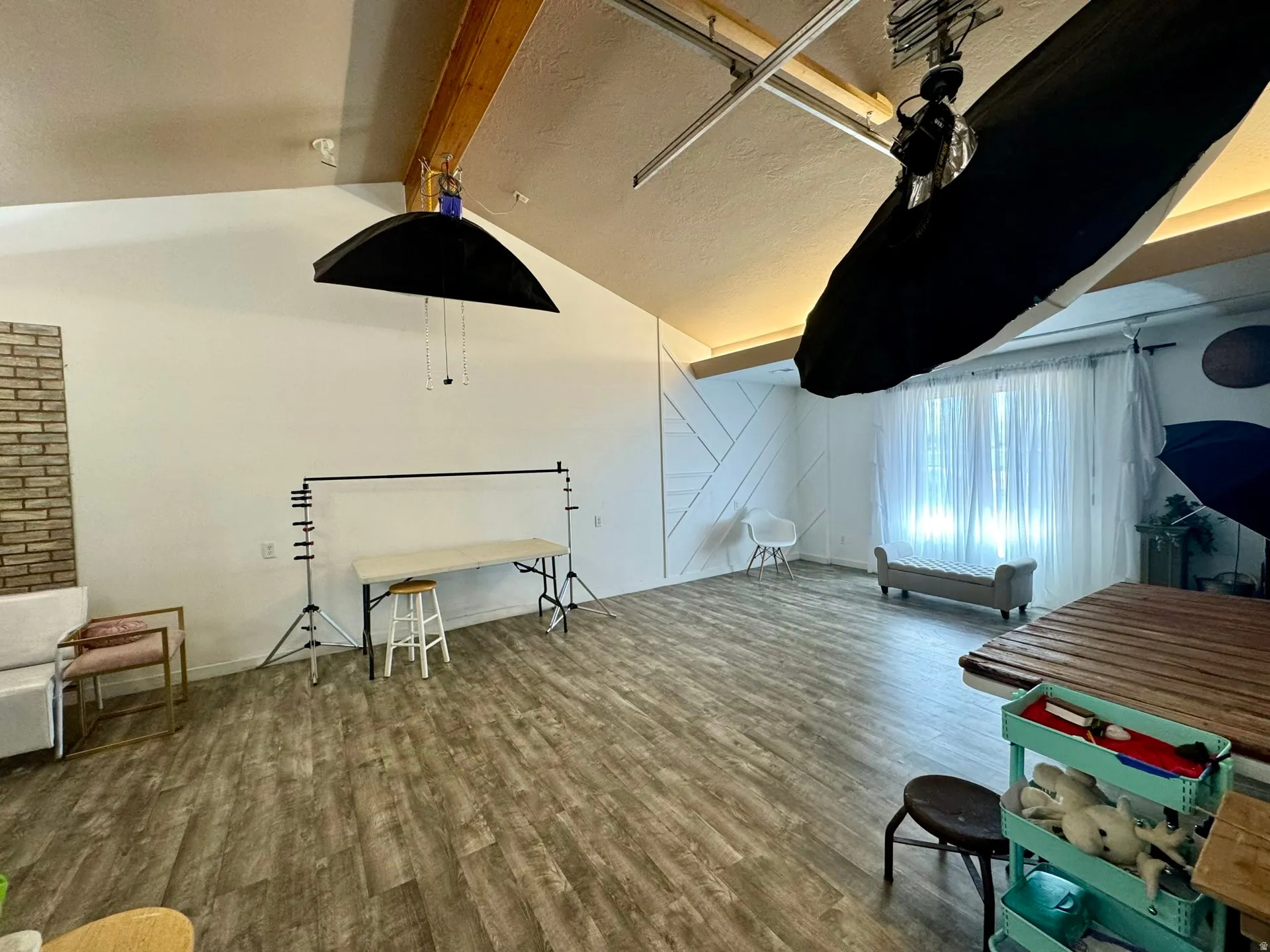 Additional living space featuring dark wood-style floors and baseboards