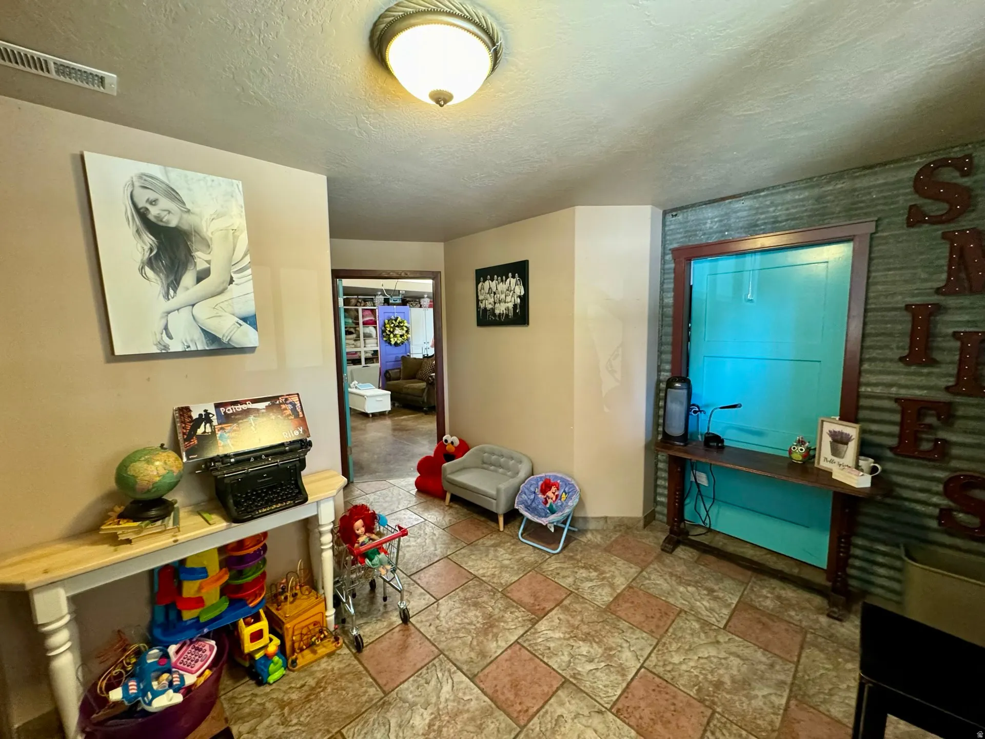 Entrance foyer featuring stone finish flooring and a textured ceiling