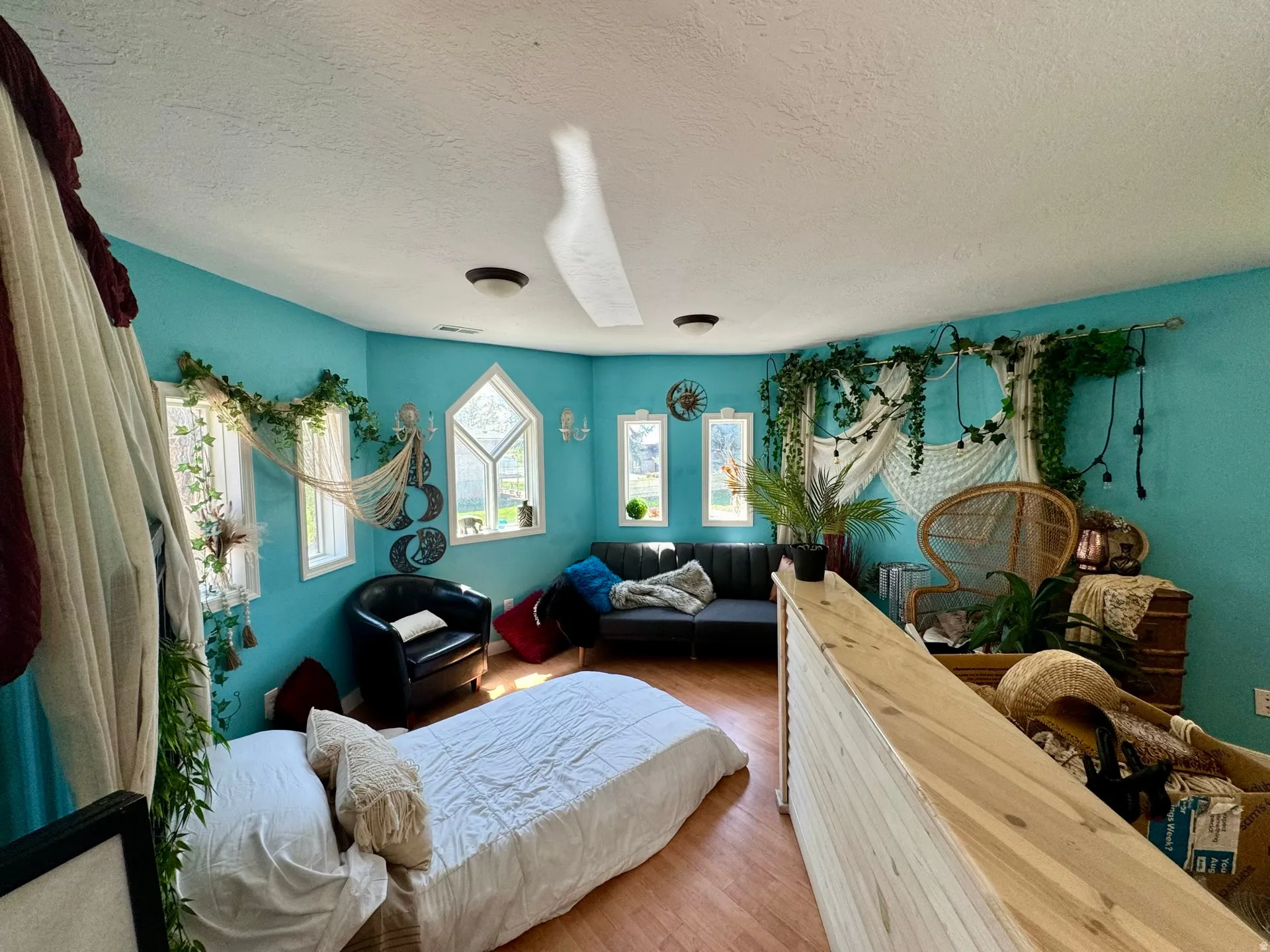 Bedroom featuring a textured ceiling and wood finished floors