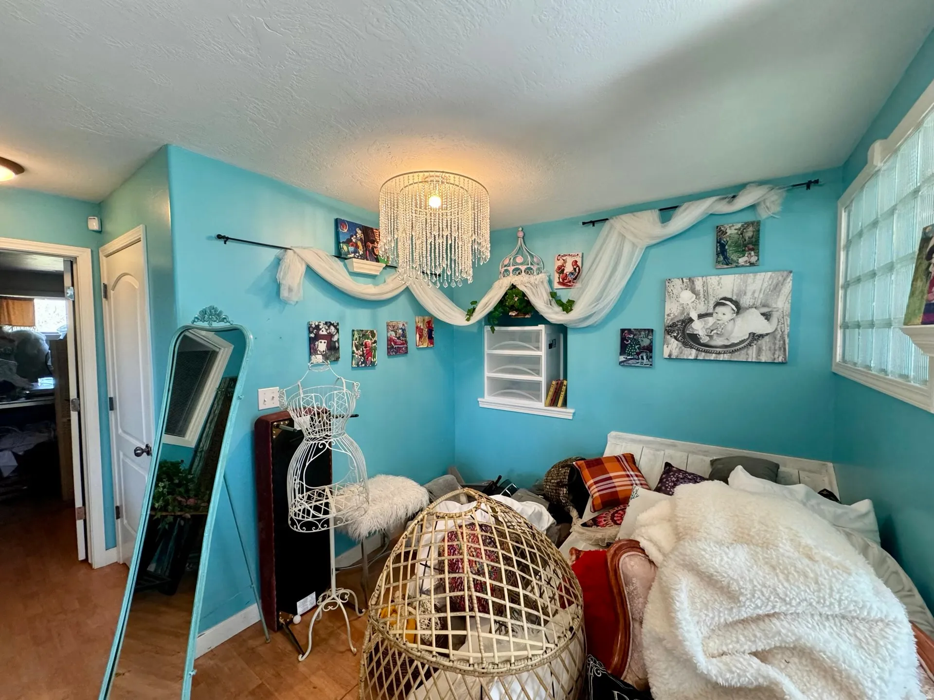 Bedroom featuring a chandelier, wood finished floors, a closet, and a textured ceiling