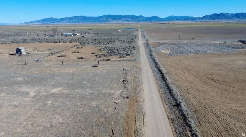 Overview of rural landscape featuring a mountain backdrop and a desert landscape