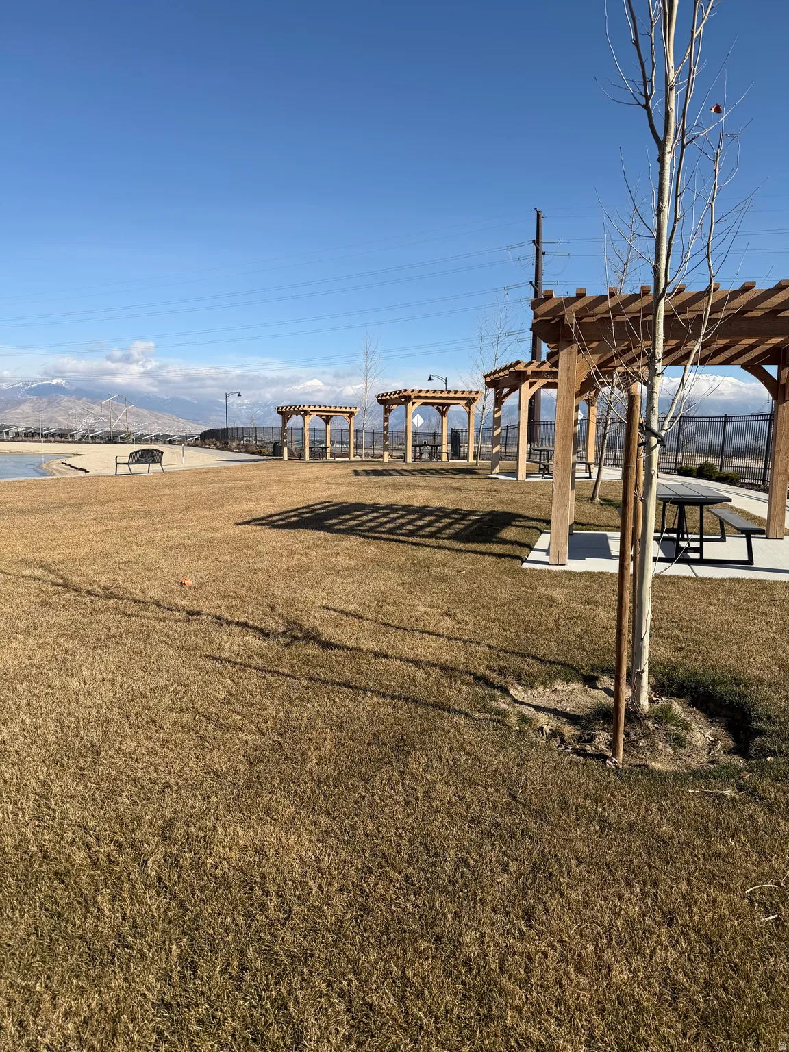 View of green lawn featuring a pergola, a patio area, and a mountain view