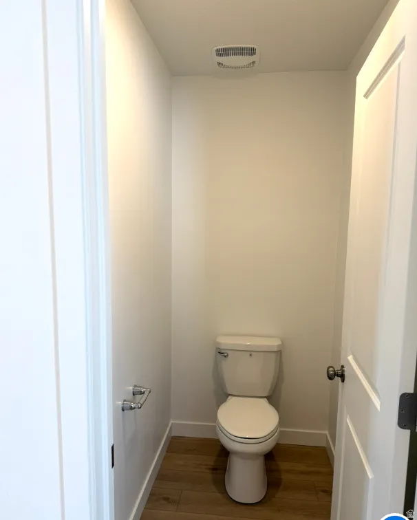 Bathroom featuring baseboards and wood finished floors