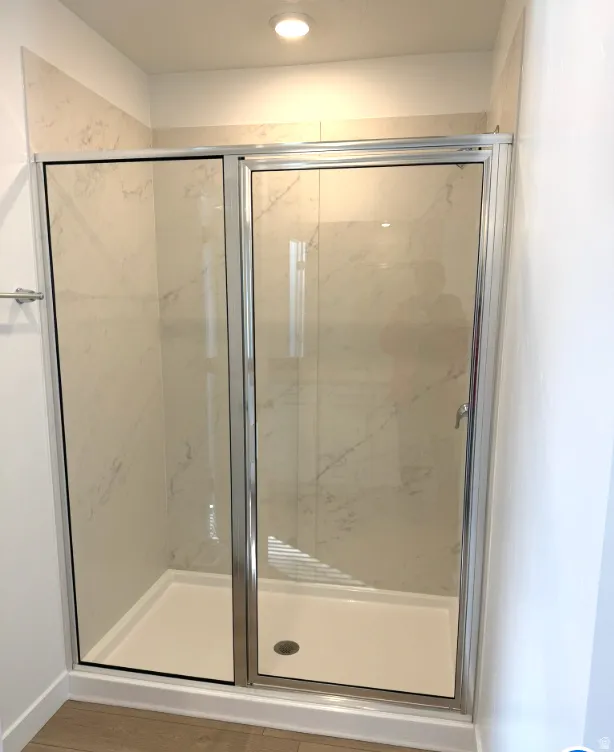 Full bathroom featuring a marble finish shower and recessed lighting