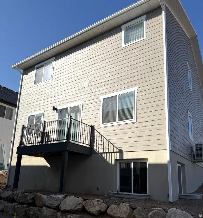 Rear view of property with a wooden deck