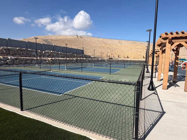 View of tennis court with a pergola