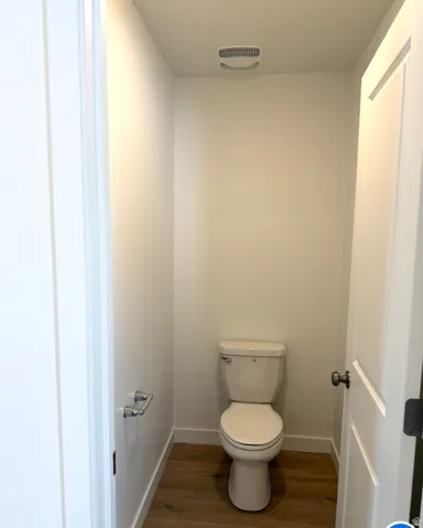 Bathroom featuring baseboards and wood finished floors