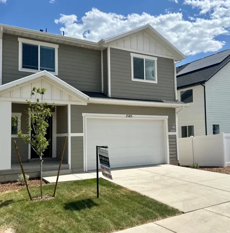 Two-story residence featuring horizontal siding and white trim
