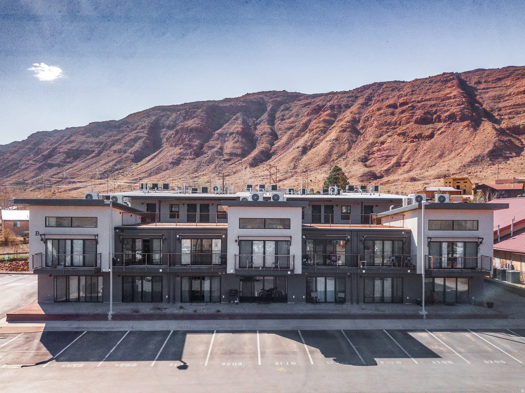 View of property featuring a mountain view and uncovered parking