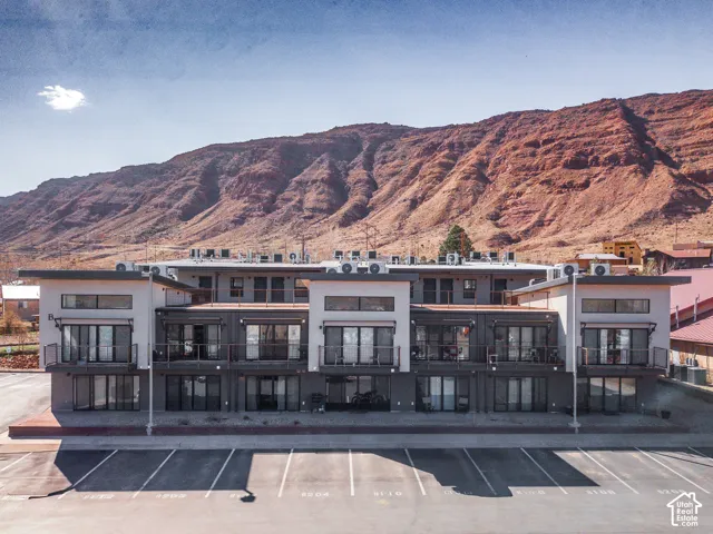 View of property featuring a mountain view and uncovered parking