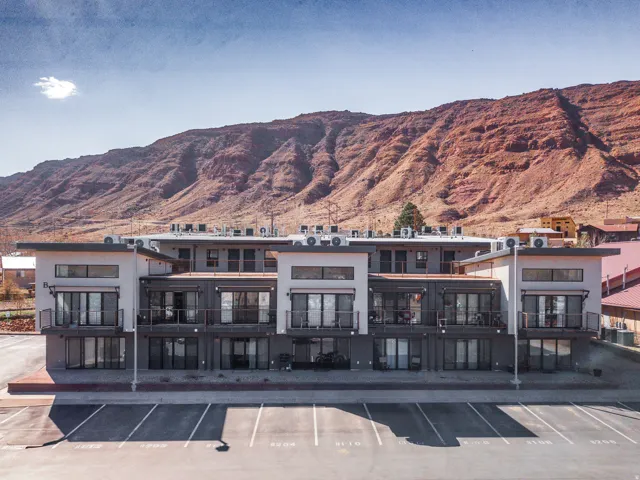 View of property featuring a mountain view and uncovered parking