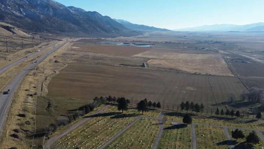 View of rural area with a mountain backdrop and abundant farmland