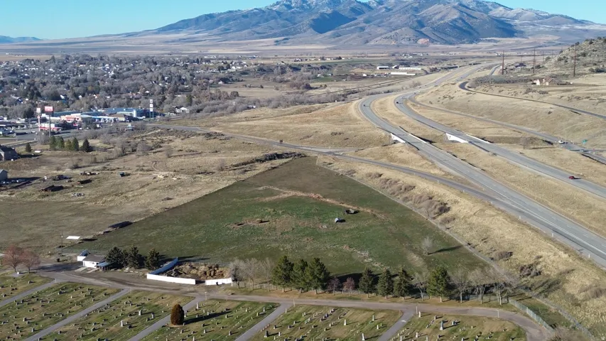 Aerial view of property and surrounding area with a mountain backdrop and rural landscape