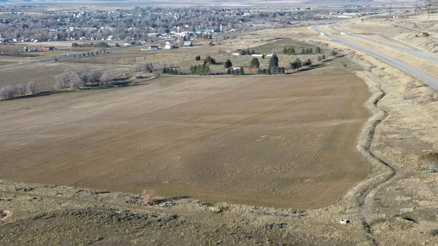 Aerial overview of property's location featuring rural landscape and large plots for crops