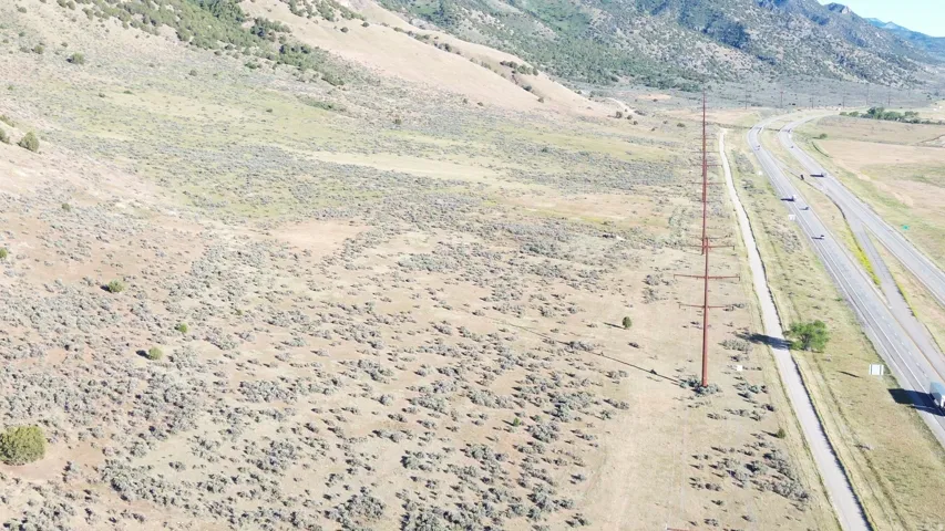 Expansive land parcel featuring natural, arid vegetation and a mountainous backdrop