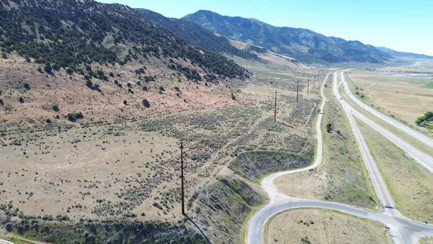 Expansive undeveloped land featuring natural terrain and distant mountains