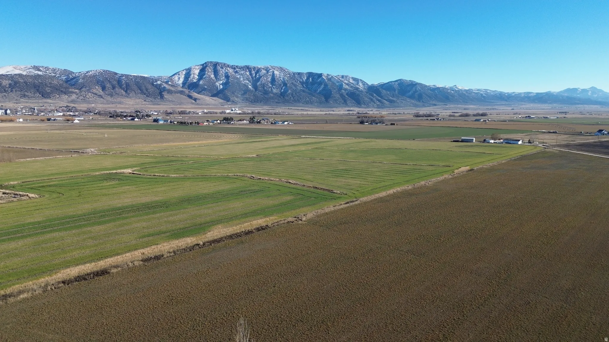 View of mountain backdrop with rural landscape and farmland