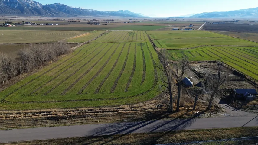 Aerial view of sparsely populated area featuring farmland and mountains