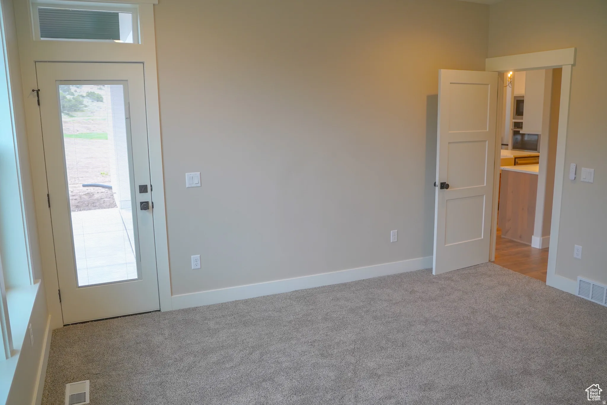 Carpeted empty room with baseboards