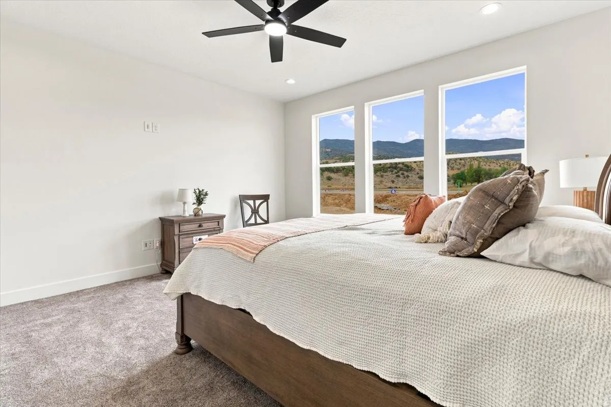 Carpeted flooring, recessed lighting, and a ceiling fan