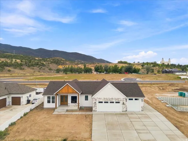 Contemporary ranch-style residence featuring a prominent front-facing garage with two separate doors