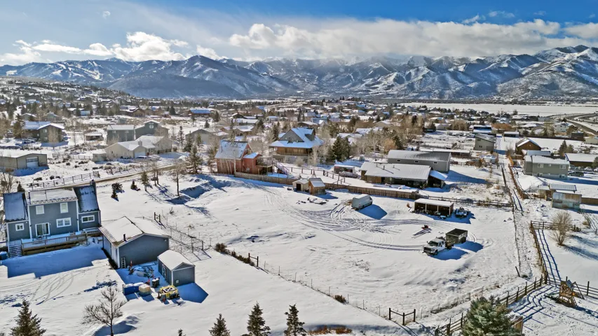 Snowy aerial view with a residential view and a mountain view