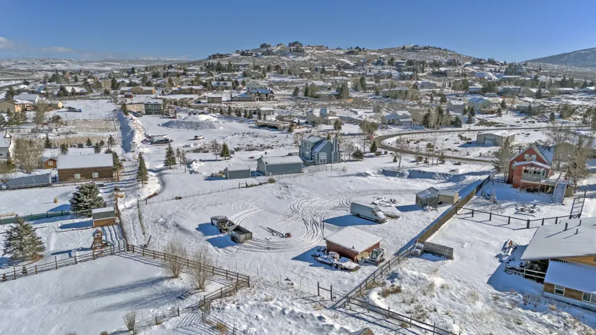 Snowy aerial view with a residential view and a mountain view