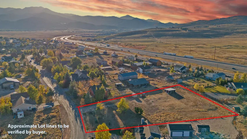 Aerial view at dusk of a mountain view, property parcel outlined, and a residential view