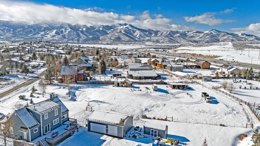 Snowy aerial view with a residential view and a mountain view