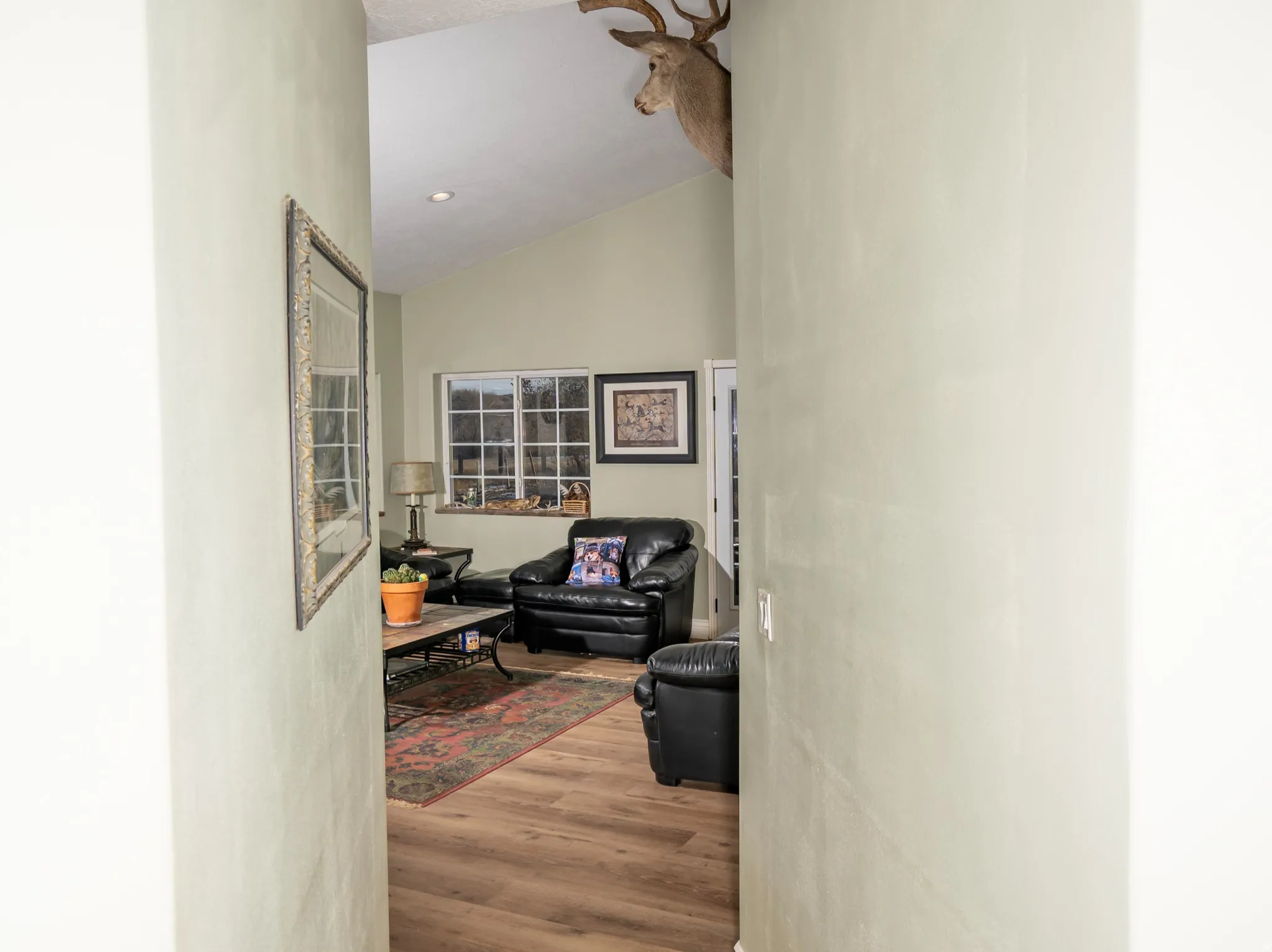 Corridor featuring lofted ceiling and light wood-type flooring