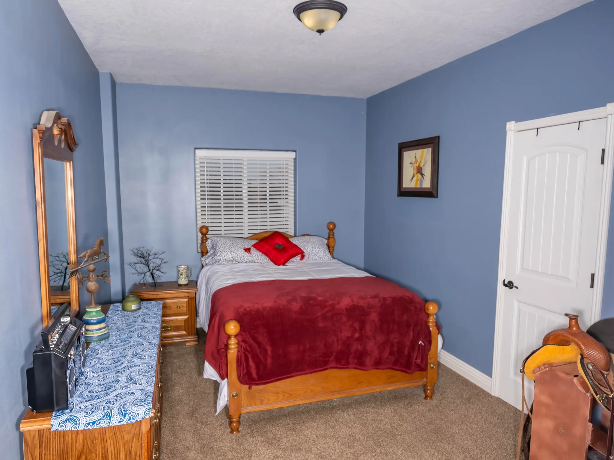 Bedroom featuring baseboards and carpet floors
