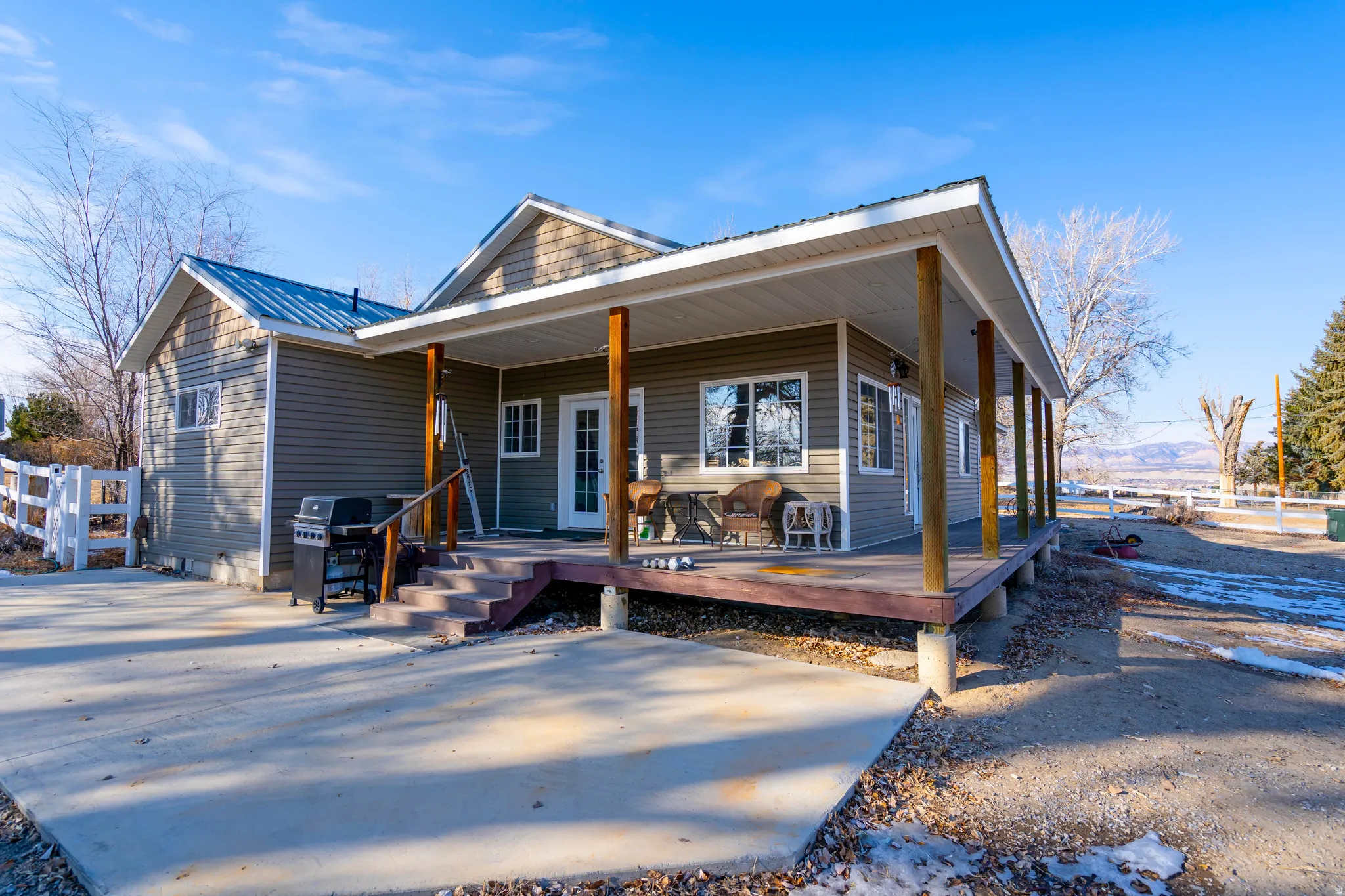 View of front of property featuring covered porch and a metal roof