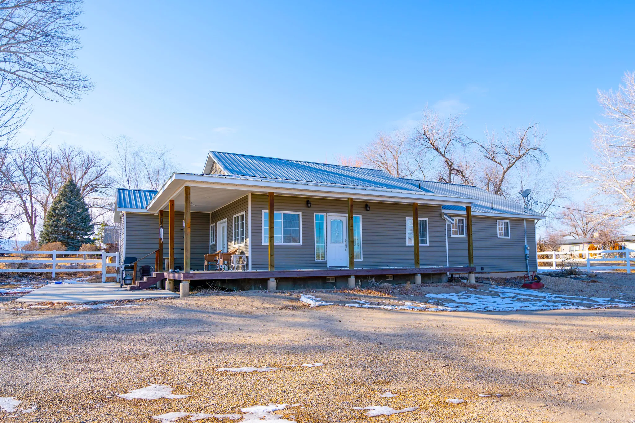 View of front of property with a metal roof and covered porch